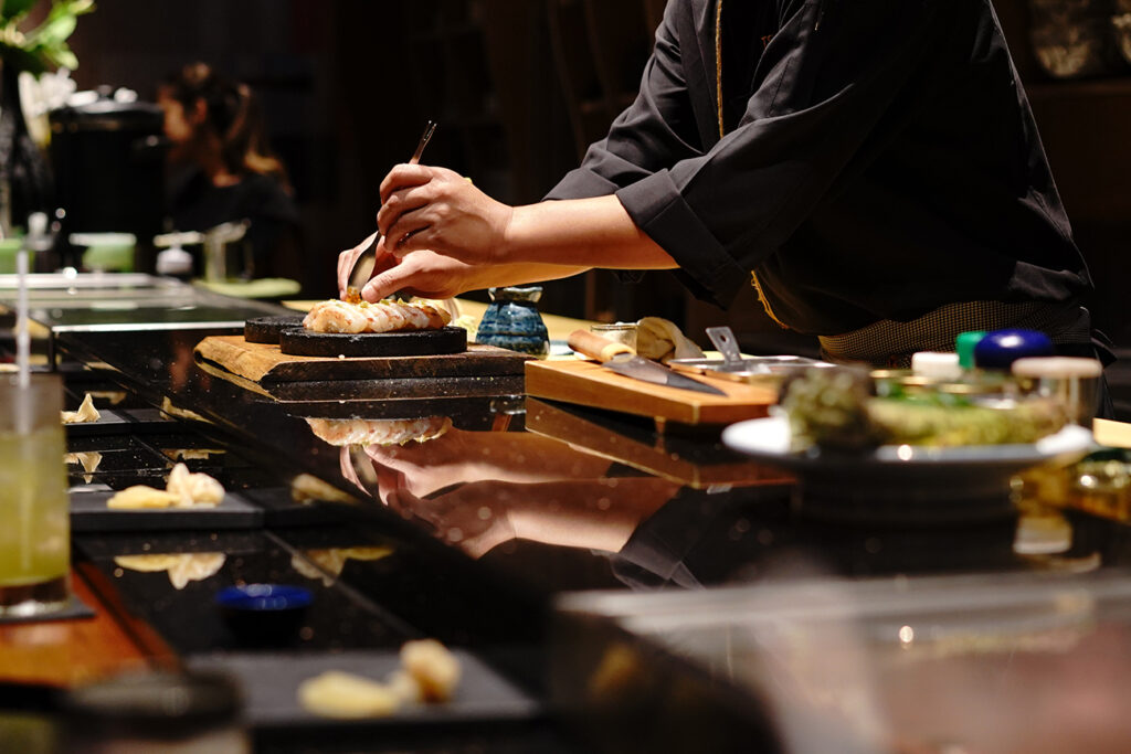 Japanese Chef making uni nigiri omakase style eating. Omakase style Japanese traditional.